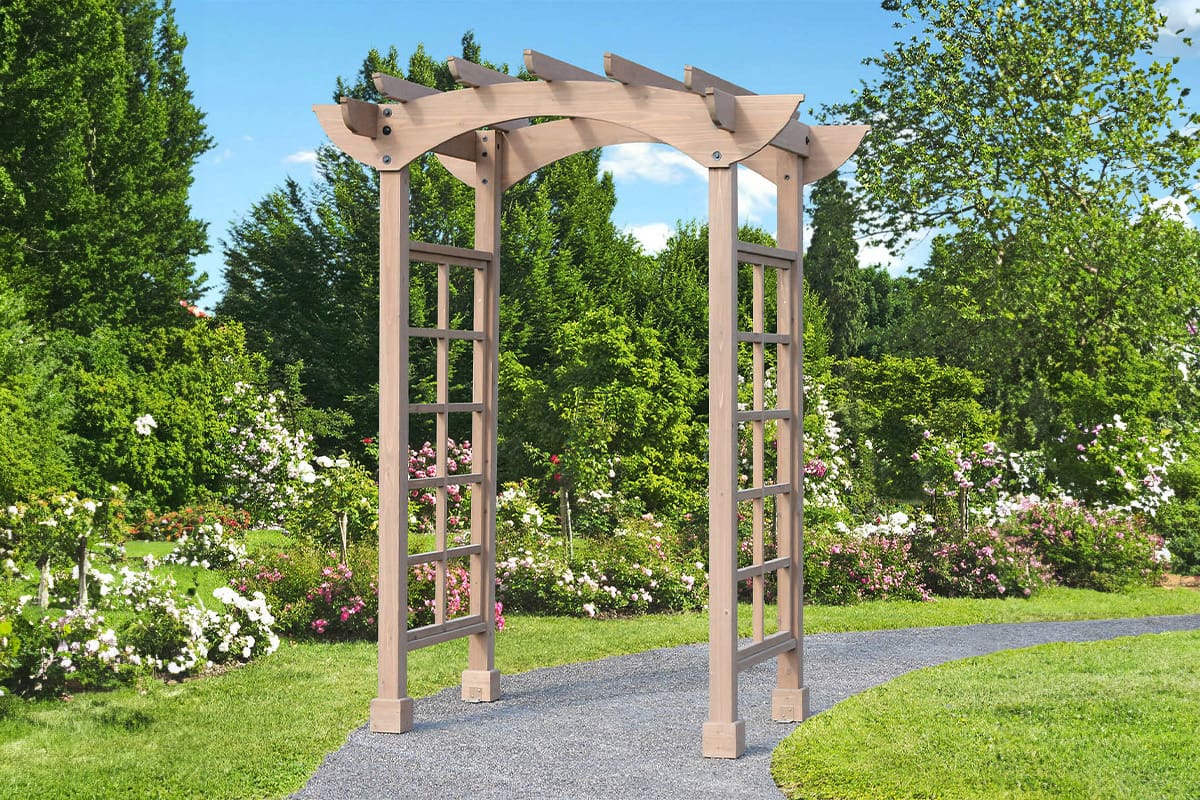 Wood arbour over walkway in garden