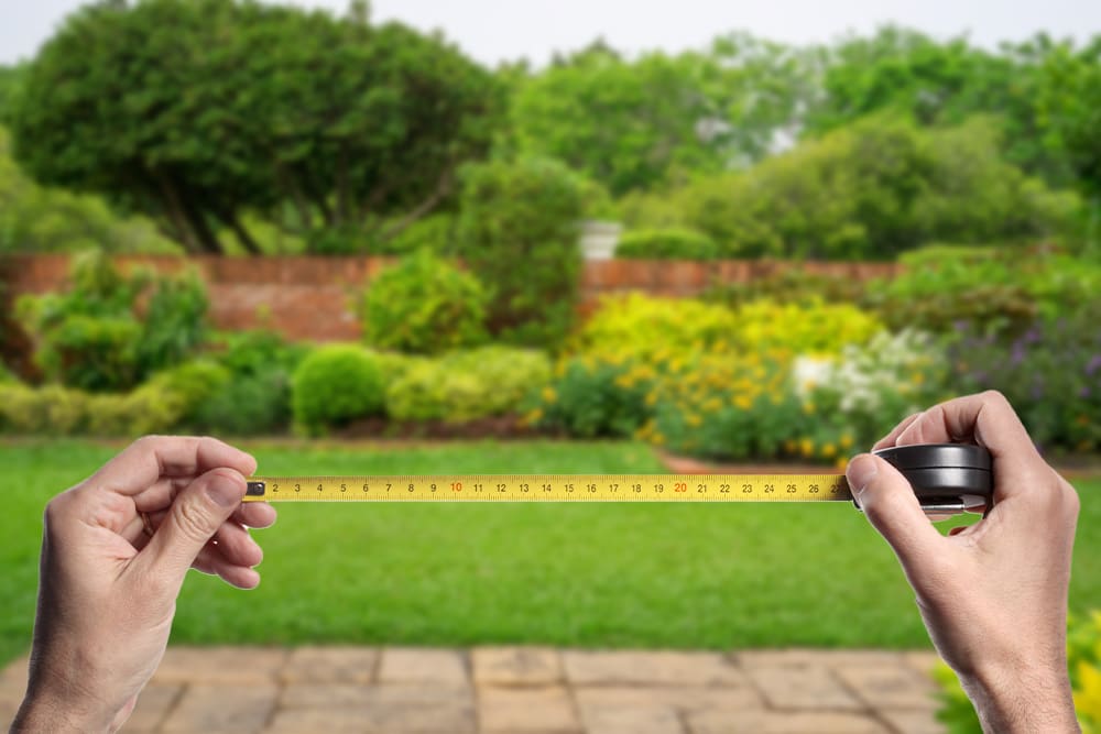 Backyard scene with measuring tape in foreground