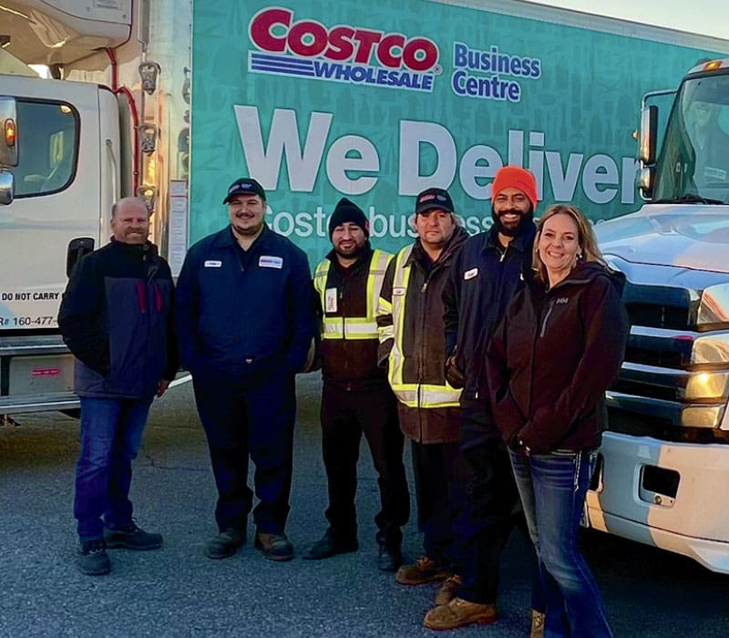 business center employees in front of Costco building