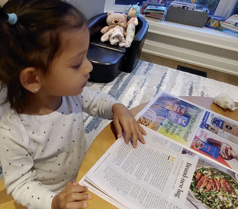 little girl reading Costco