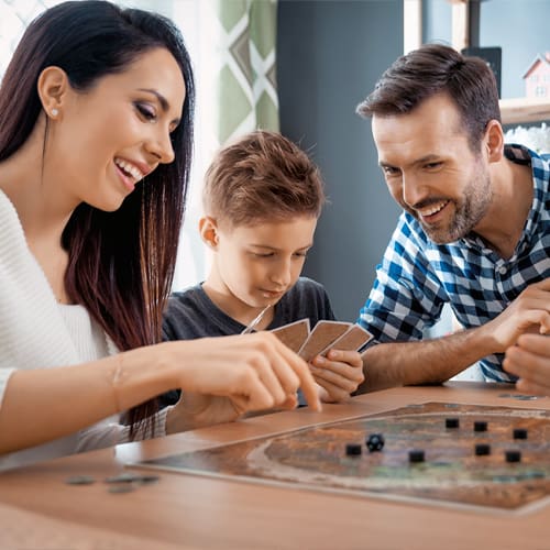 man, woman and child playing a game