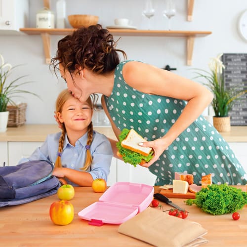 woman with child packing a lunch