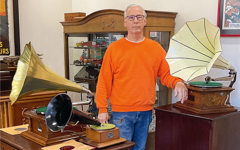 a man with antique phonographs