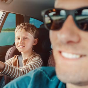 a boy and a man inside a car