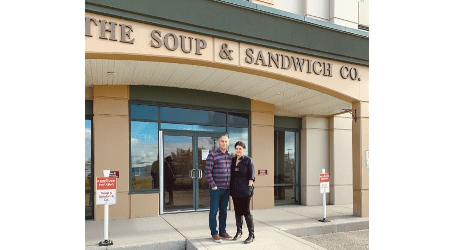 two people in front of a shop