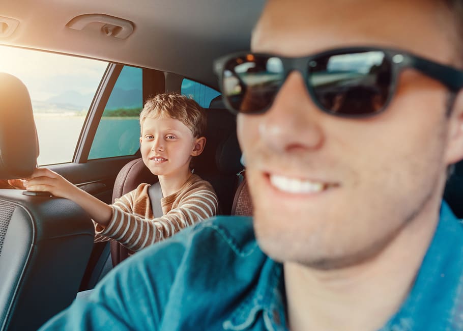 a young boy and a man in a car