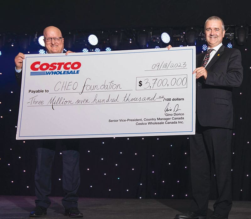 two men holding a giant check