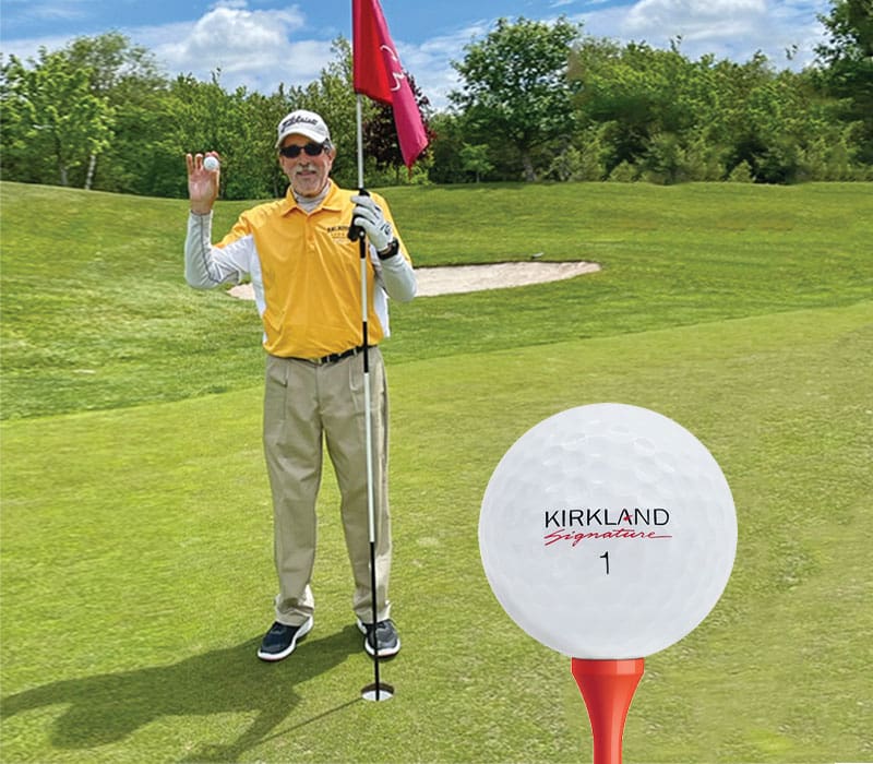 man on the golf course holding a golf ball