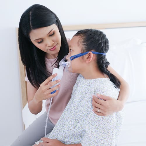 mom and child in a hospital room hugging