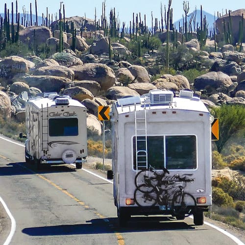 Couple hugging with RV in the background