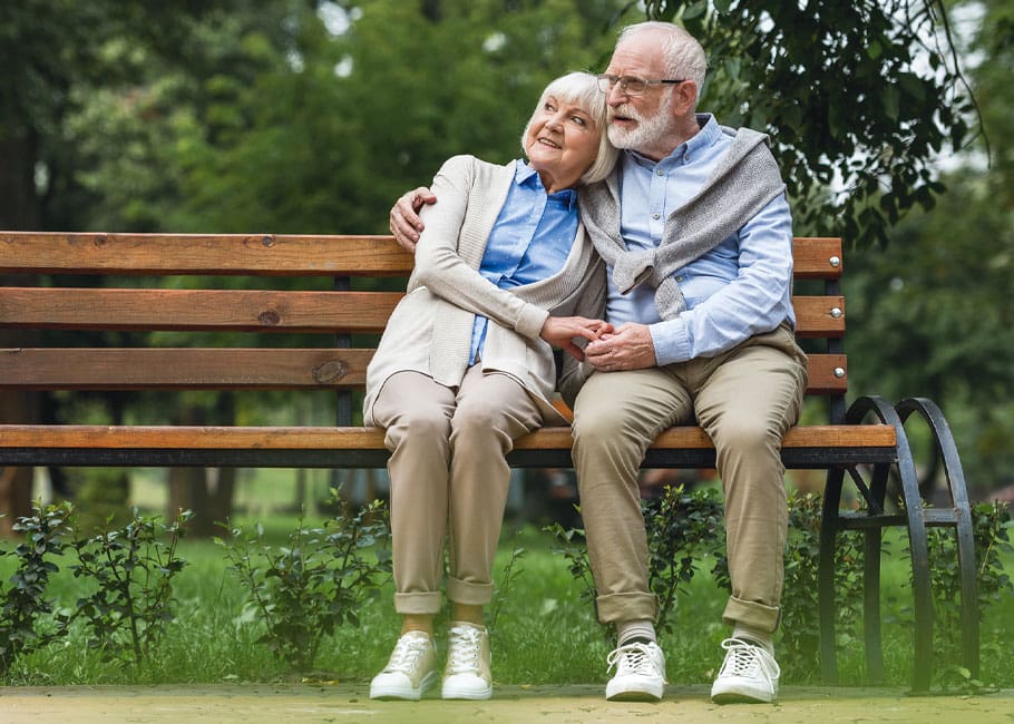 senior couple sitting on a bench