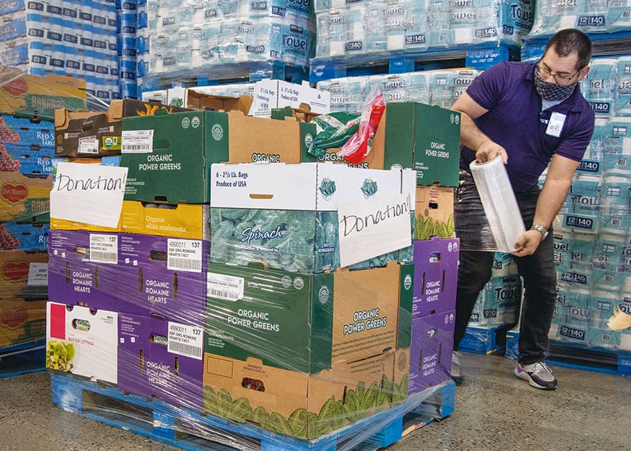 Costco produce supervisor Alex Rohrer prepares a pallet for donation.