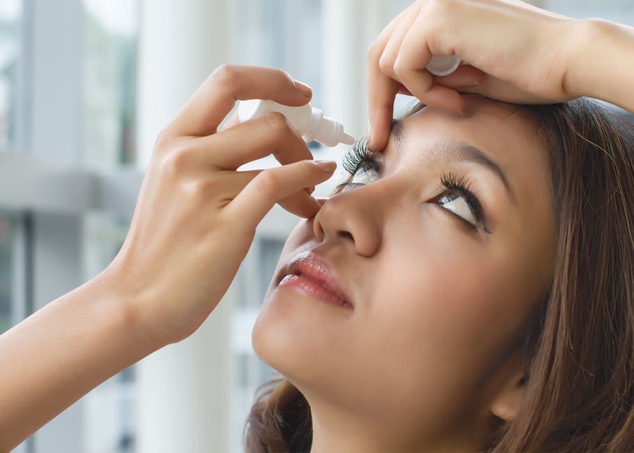 woman putting eye drops in