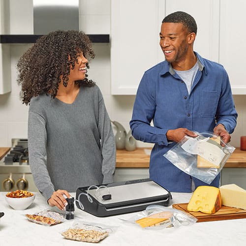 two people using a food sealer