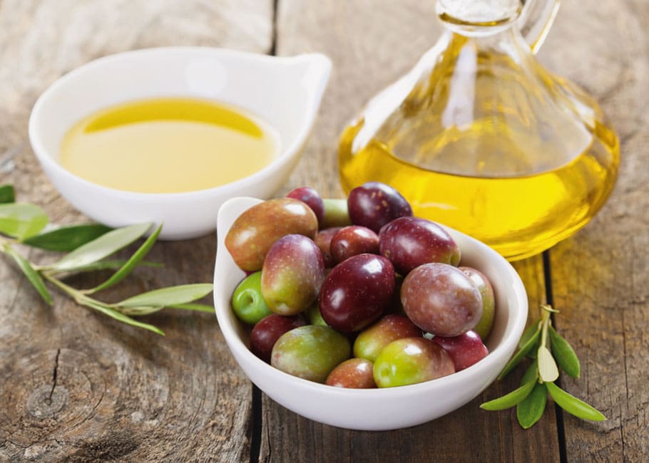 Table with olives and olive oil in bowls