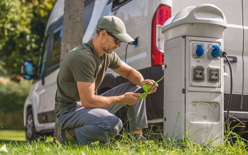 man plugging RV into power