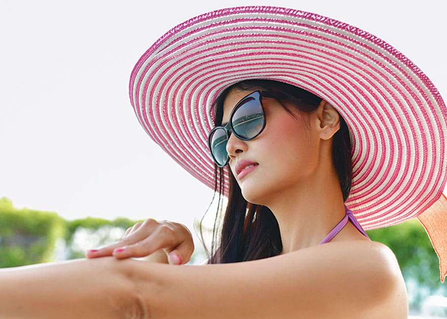 woman wearing hat and sunglasses