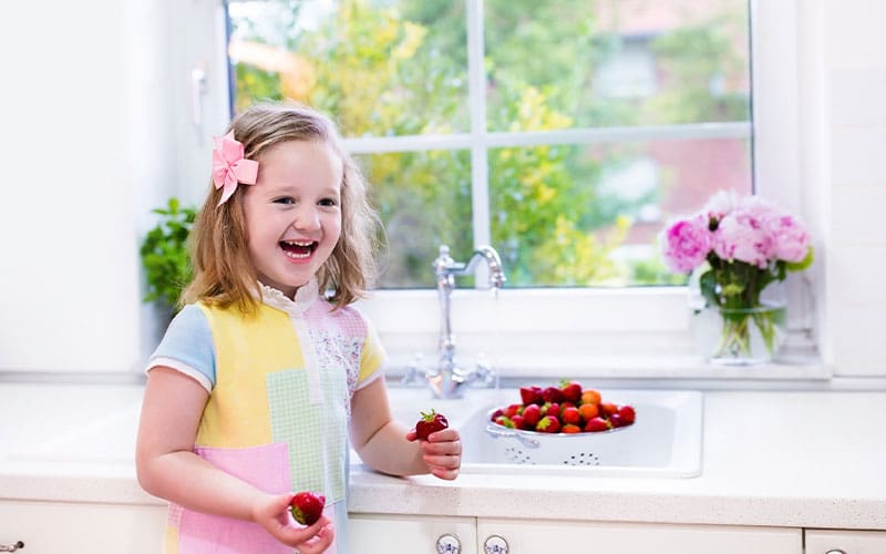 little girl with strawberries