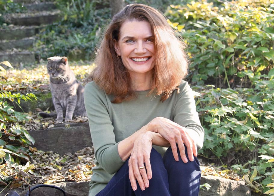 woman smiling in front of grass