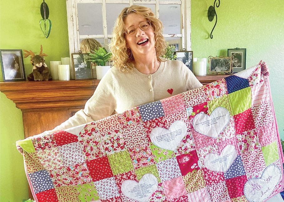 woman holding a quilt