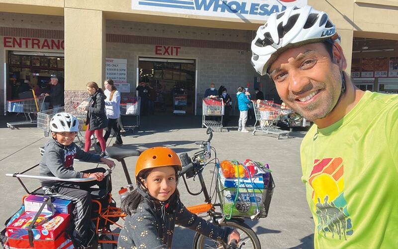 man and kids on bike