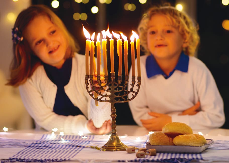children with a lit menorah