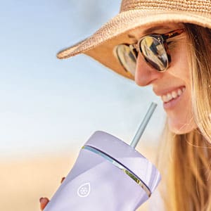 woman sipping from a tumbler