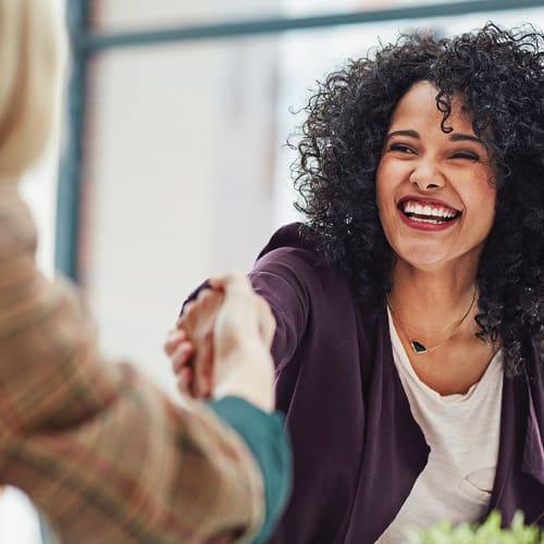 Costco member services image of woman shaking someone's hand