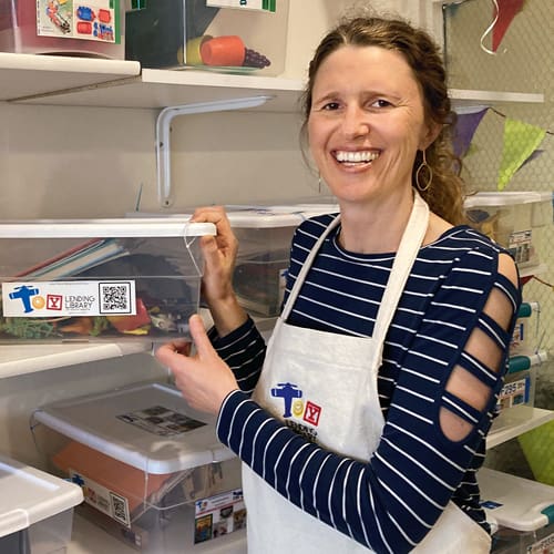 Member Connection: The joys of toys image of founder smiling next to toys