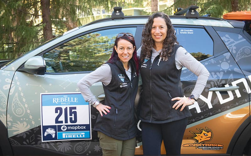 two women next to a car