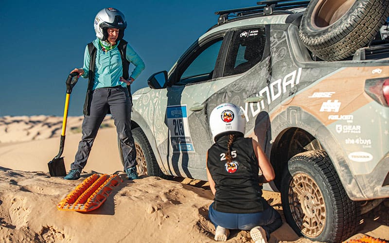 two women fixing car