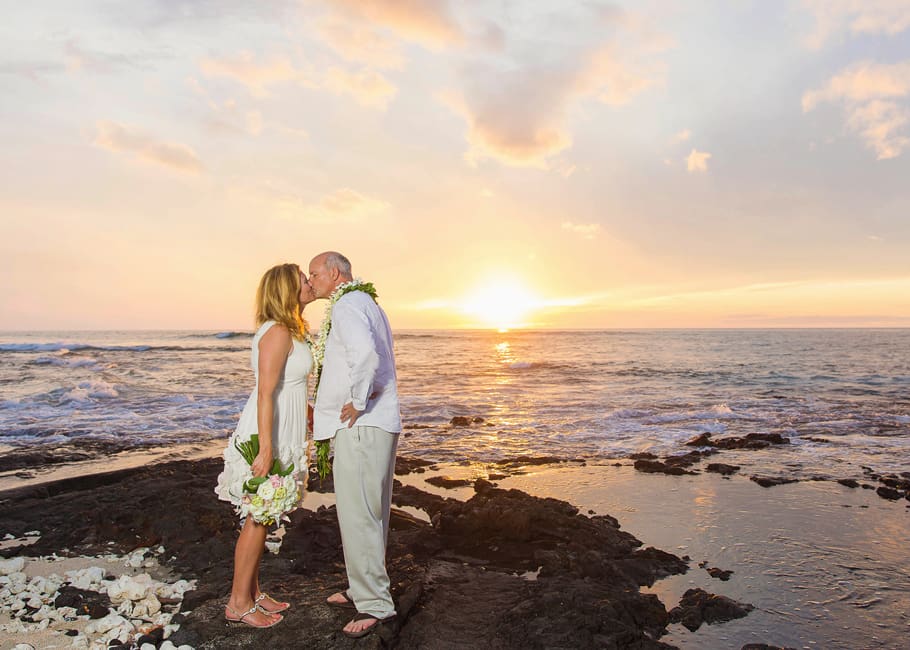 couple kissing on beach at sunset