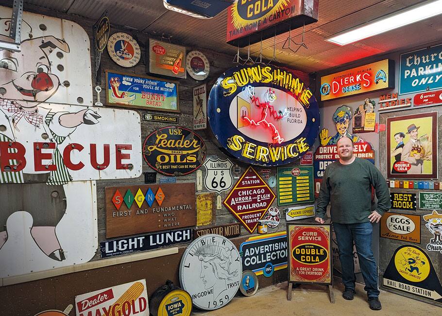 man in front of vintage signs