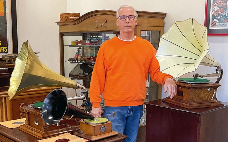 man with antique phonographs