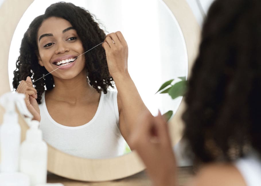 woman flossing teeth