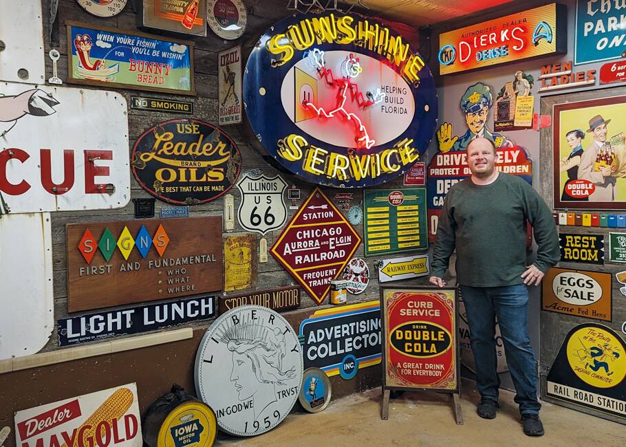 man in front of collection of signs