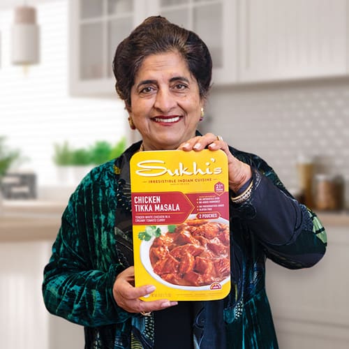 Woman holding box of Indian food