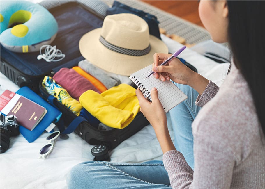 woman packing with list