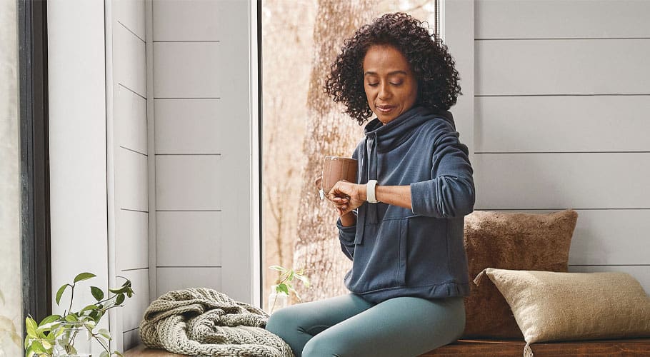 woman looking at smart watch