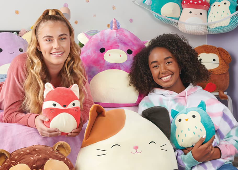 2 girls holding squishmallows