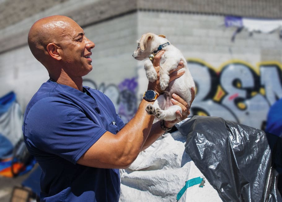 a man holding a puppy